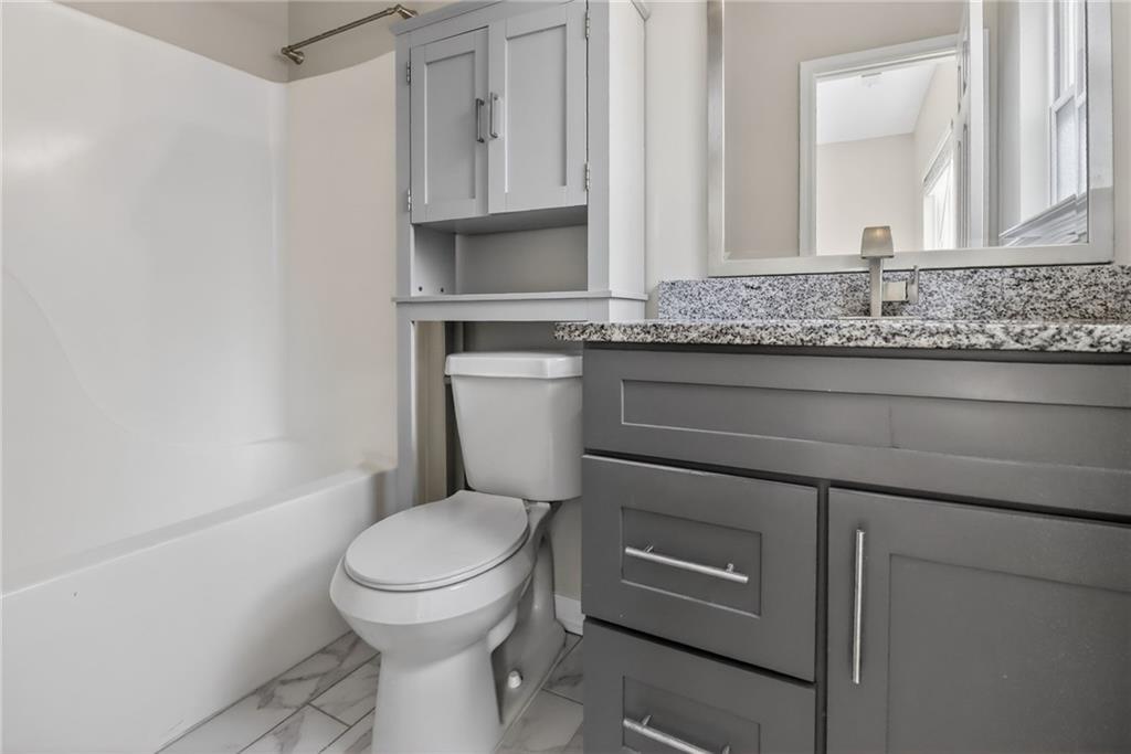 991 Ada Avenue Northwest Atlanta, GA 30318 - Photo 22 of 32 a bathroom with a toilet a sink and a window