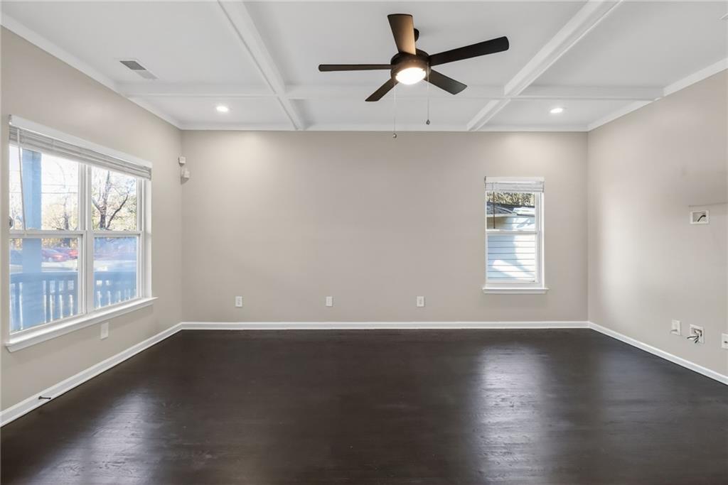 991 Ada Avenue Northwest Atlanta, GA 30318 - Photo 4 of 32 an empty room with wooden floor fan and windows