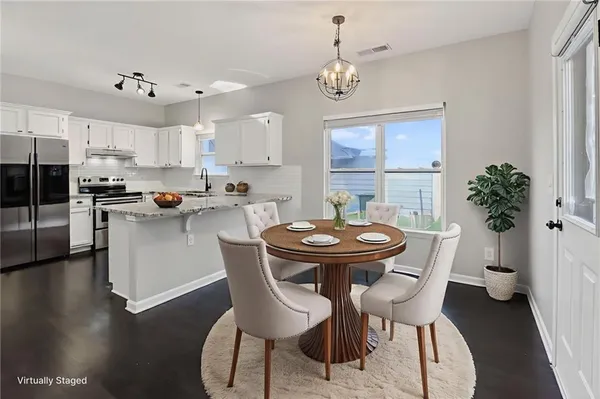 a kitchen with granite countertop a sink cabinets and stainless steel appliances