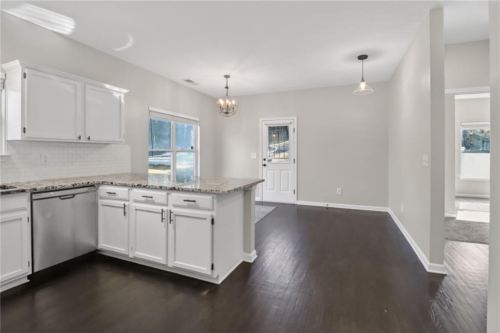 991 Ada Avenue Northwest Atlanta, GA 30318 - Photo 10 of 32 a kitchen with granite countertop white cabinets and white appliances