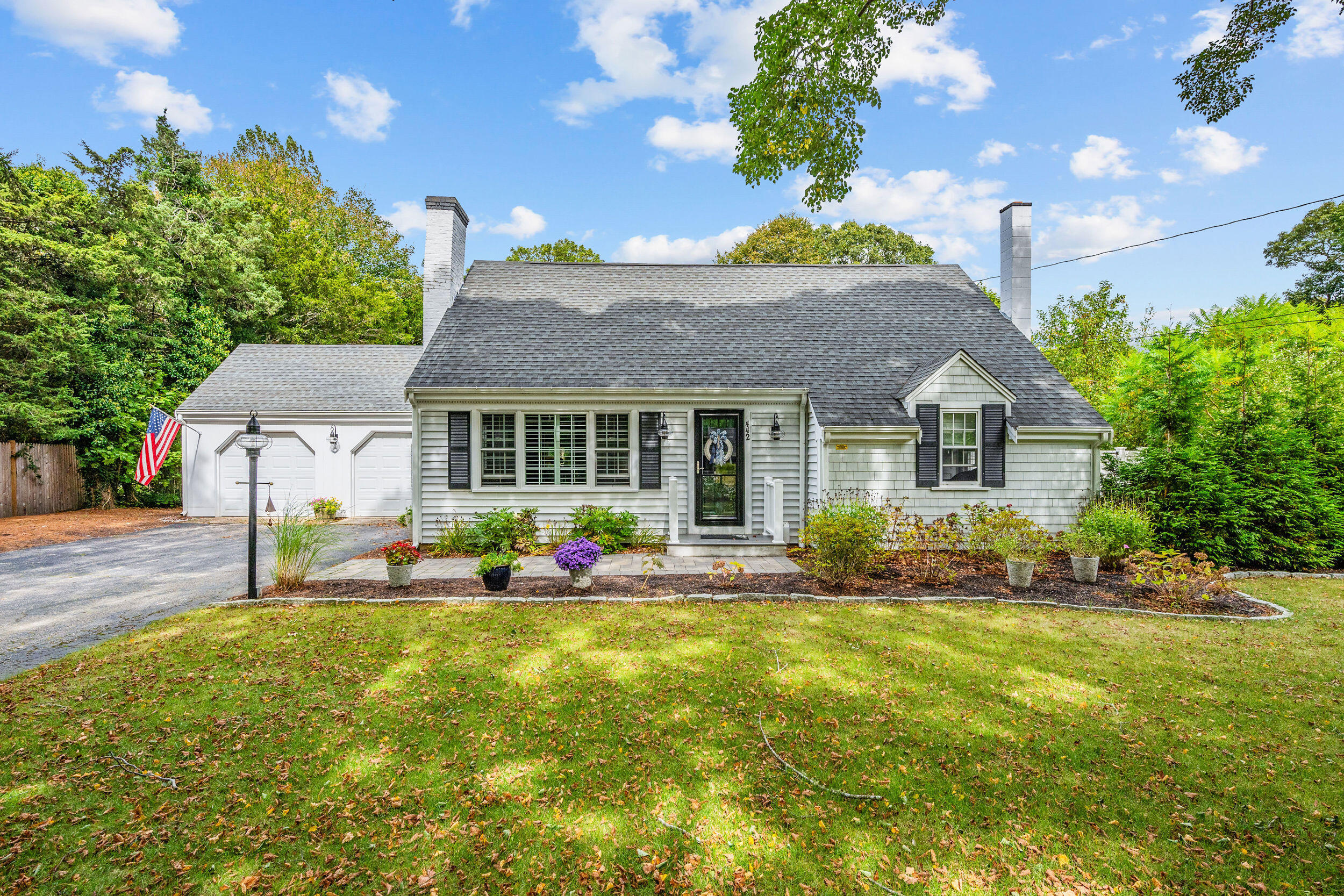 a front view of house with yard and outdoor seating