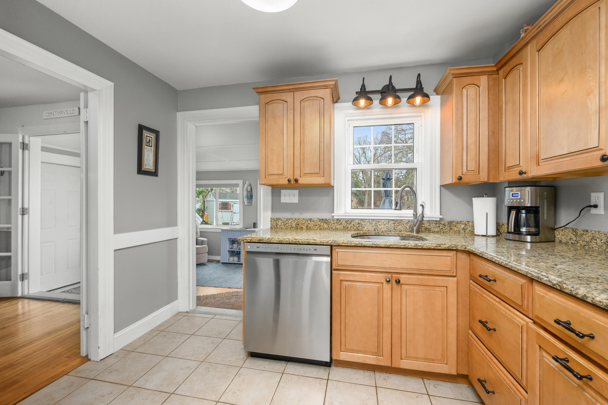 442 Pine Street Centerville, MA 02632 - Photo 13 of 43 a kitchen with granite countertop a sink stove and cabinets