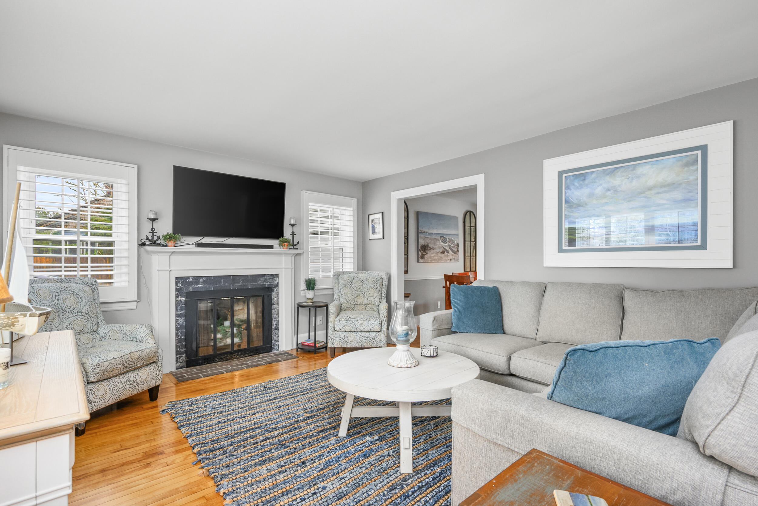 442 Pine Street Centerville, MA 02632 - Photo 4 of 43 a living room with furniture a flat screen tv and a fireplace