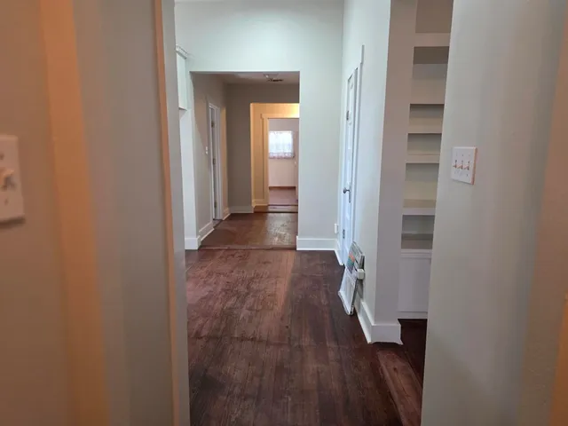 a view of hallway with wooden floor