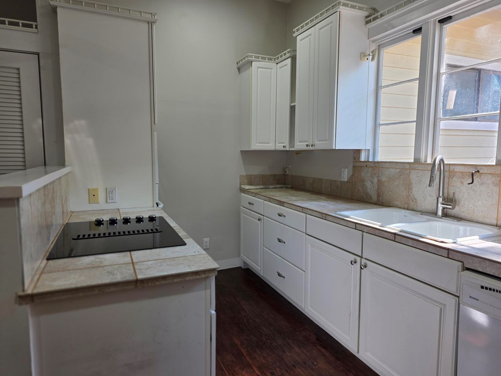 109 West Travis Street, Unit MH Fredericksburg, TX 78624 - Photo 18 of 24 a kitchen with sink a stove and cabinets