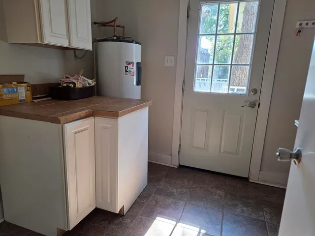 a kitchen with a refrigerator and cabinets