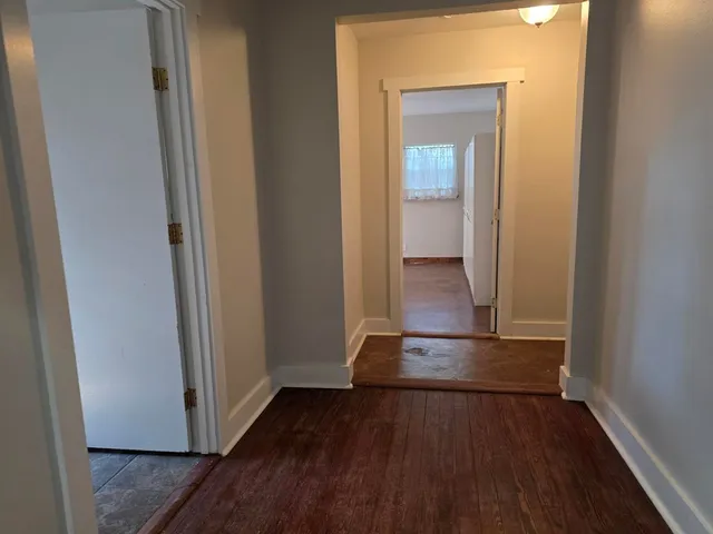 a view of a hallway with wooden floor