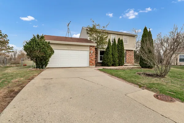 a view of a house with a yard and garage