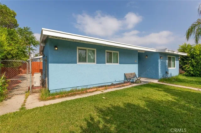a backyard of a house with table and chairs