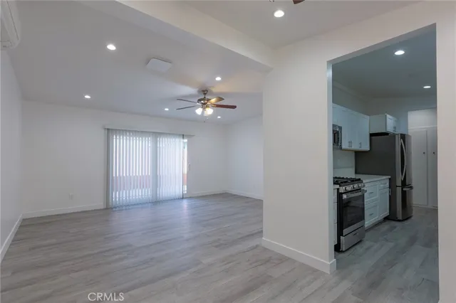 a view of a kitchen with a sink stainless steel appliances and cabinets
