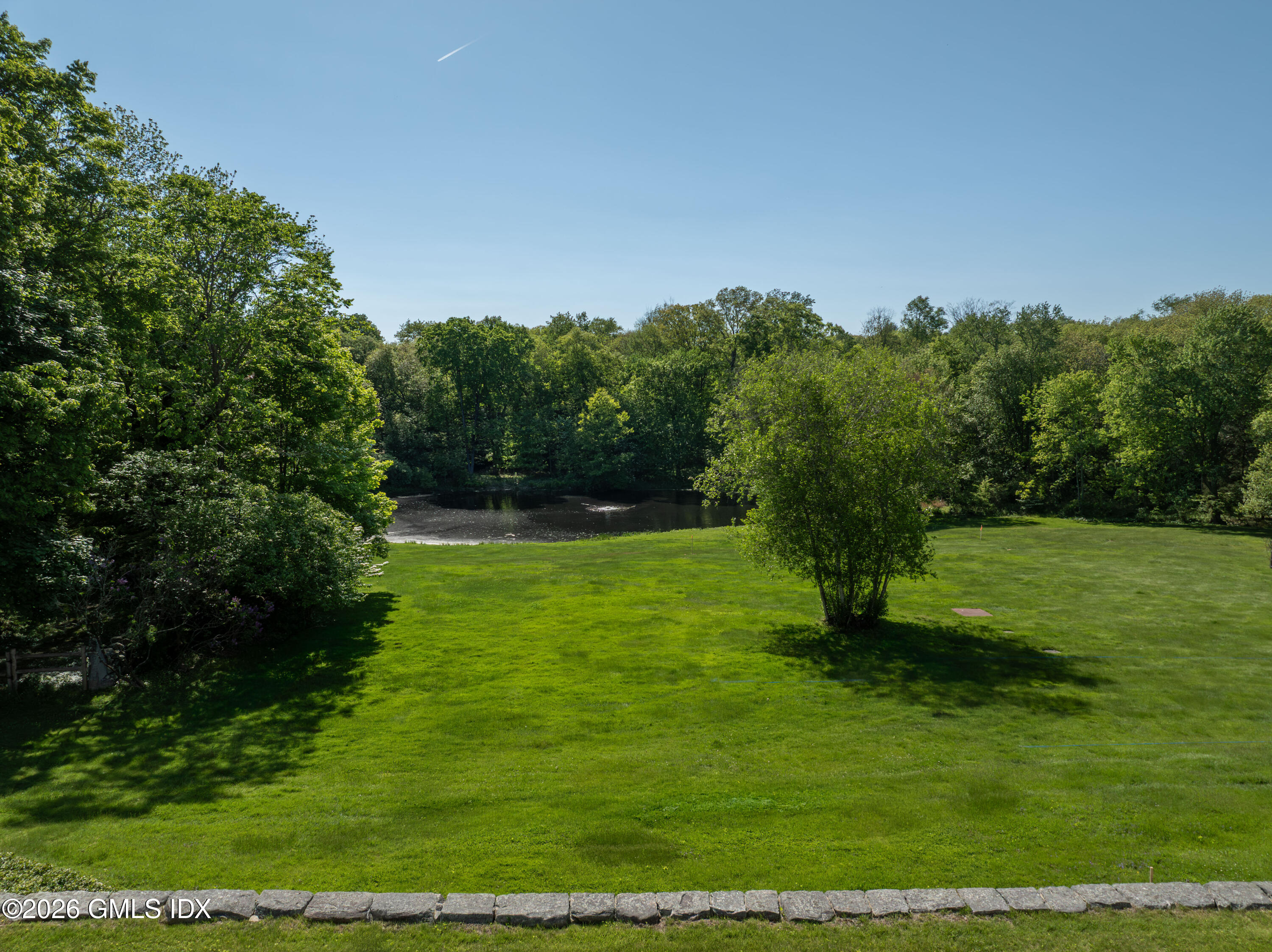 122 Round Hill Road Greenwich, CT 06831 - Photo 22 of 37 a view of a grassy field