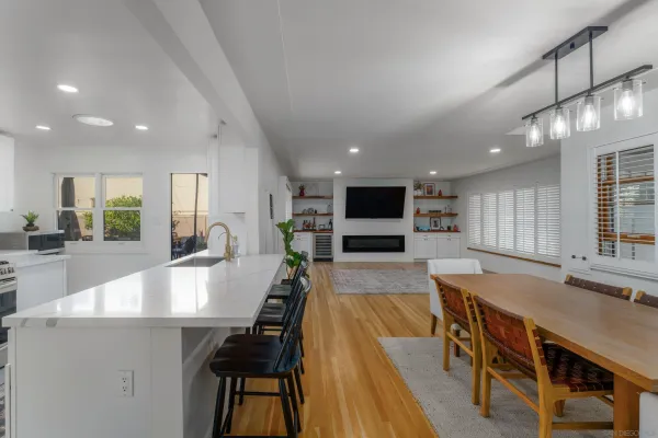 a large kitchen with lots of counter space and furniture