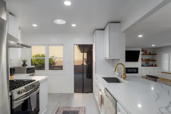 a kitchen with a stove a sink and a refrigerator