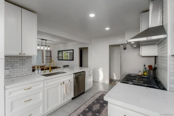 a kitchen with a sink stove and cabinets