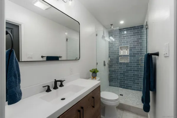 a bathroom with a sink toilet and shower