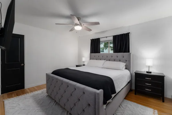 a bedroom with a bed and a flat screen tv