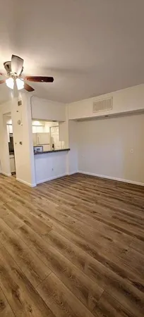 a view of a room with wooden floor