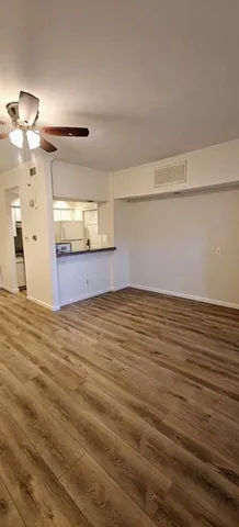 a view of a room with wooden floor
