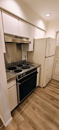 a kitchen with a stove and a refrigerator