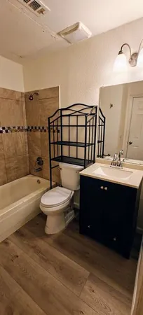 a bathroom with a sink a toilet and bathtub