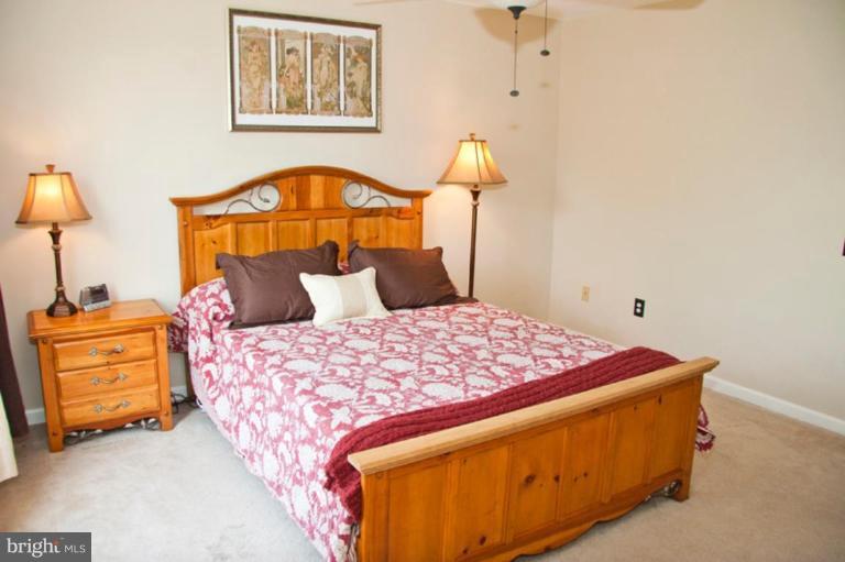 4440 Cole Farm Road Nottingham, MD 21236 - Photo 12 of 26 a bedroom with a bed and a lamp on table