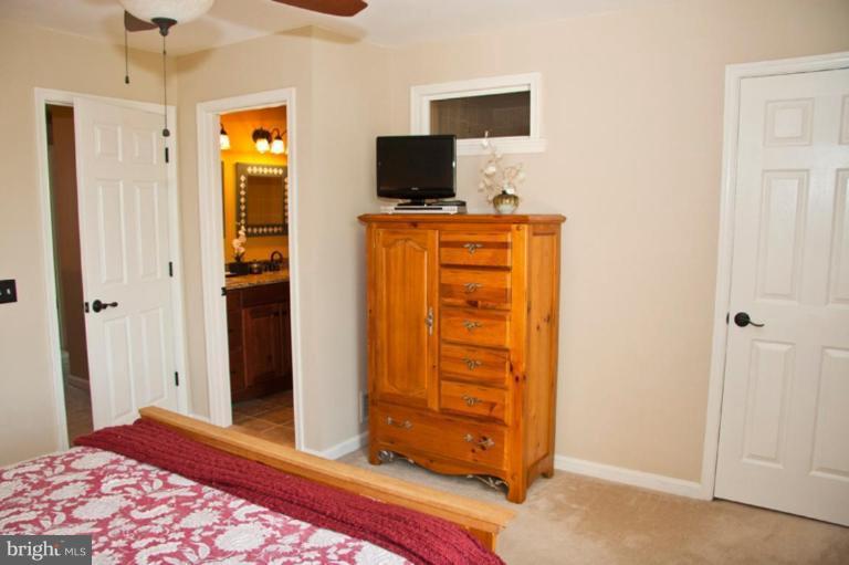 4440 Cole Farm Road Nottingham, MD 21236 - Photo 13 of 26 a bedroom with a bed and wooden floor