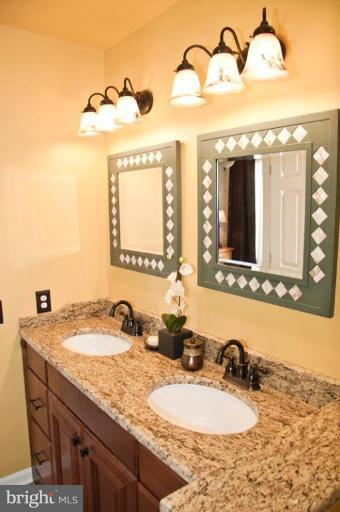 4440 Cole Farm Road Nottingham, MD 21236 - Photo 14 of 26 a bathroom with a granite countertop sink and a mirror