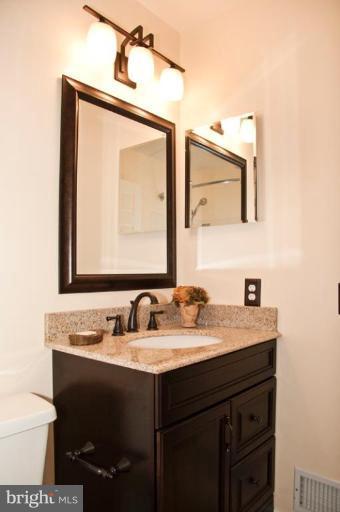 4440 Cole Farm Road Nottingham, MD 21236 - Photo 16 of 26 a bathroom with a sink vanity and a mirror