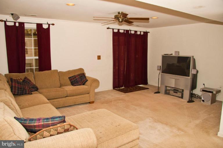 4440 Cole Farm Road Nottingham, MD 21236 - Photo 24 of 26 a living room with furniture and a flat screen tv
