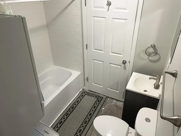a bathroom with a sink a toilet a mirror and vanity