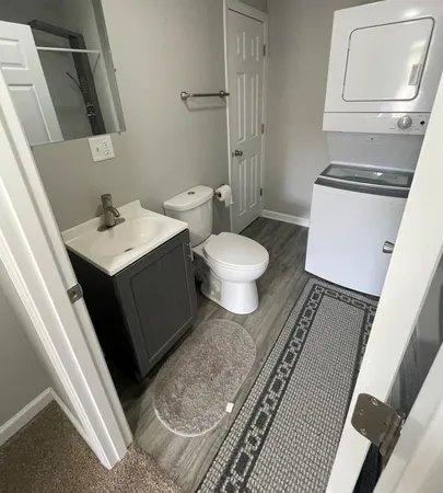 a bathroom with a sink toilet and mirror