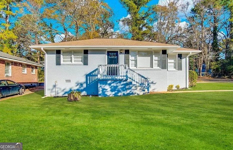 a front view of house with yard and green space