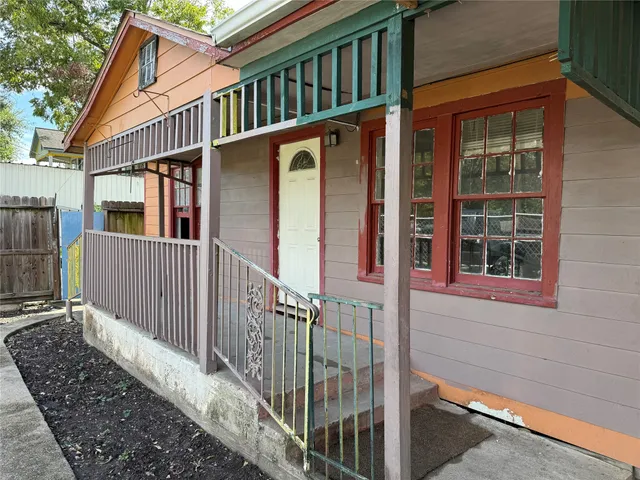 a view of a house with wooden fence