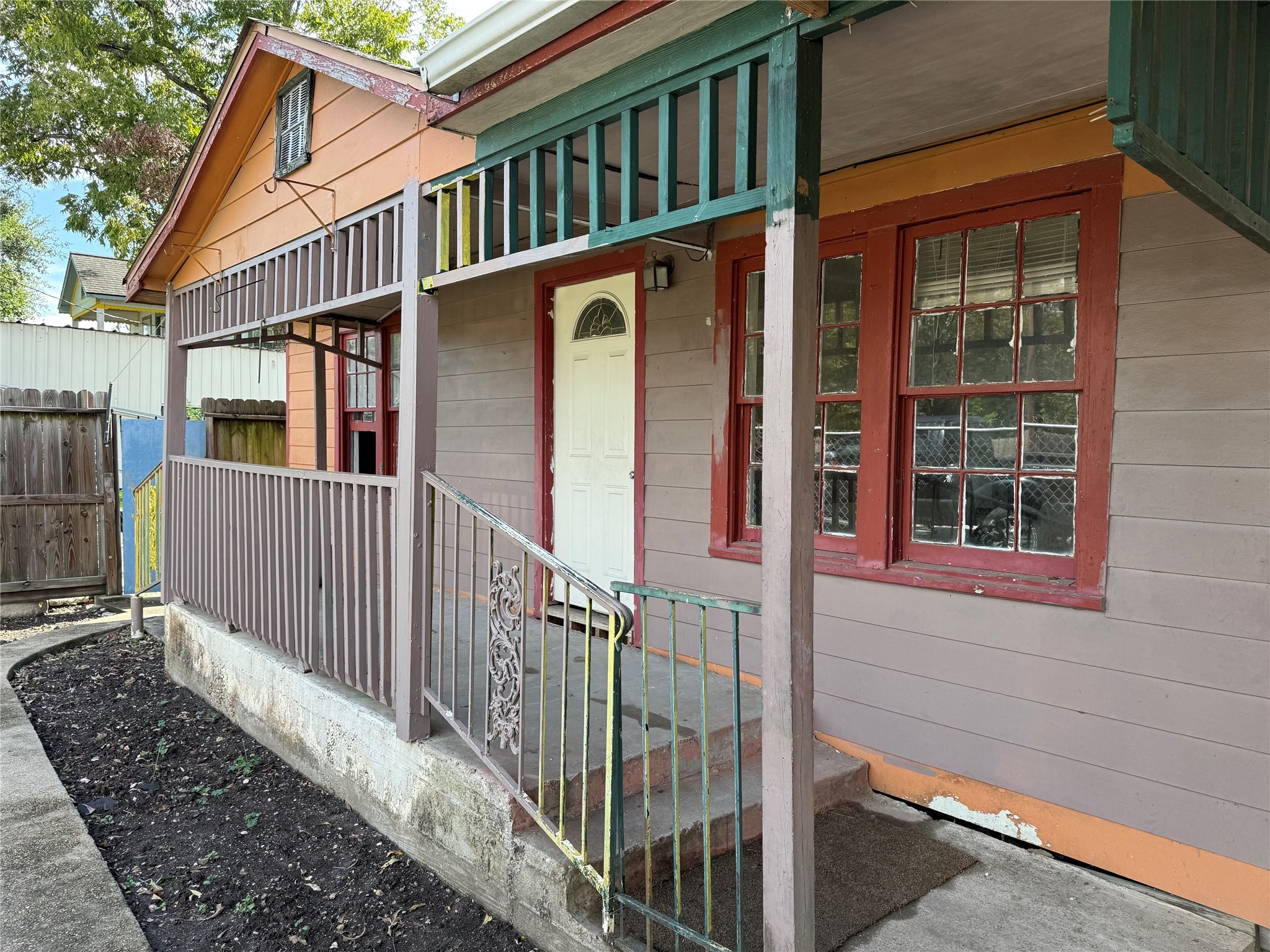 a view of a house with wooden fence