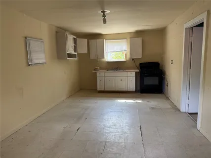 a room with a stove top oven and window