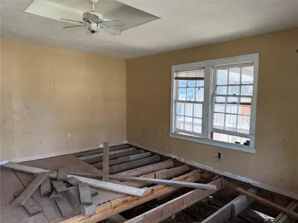 a room with exposed pipes and a window