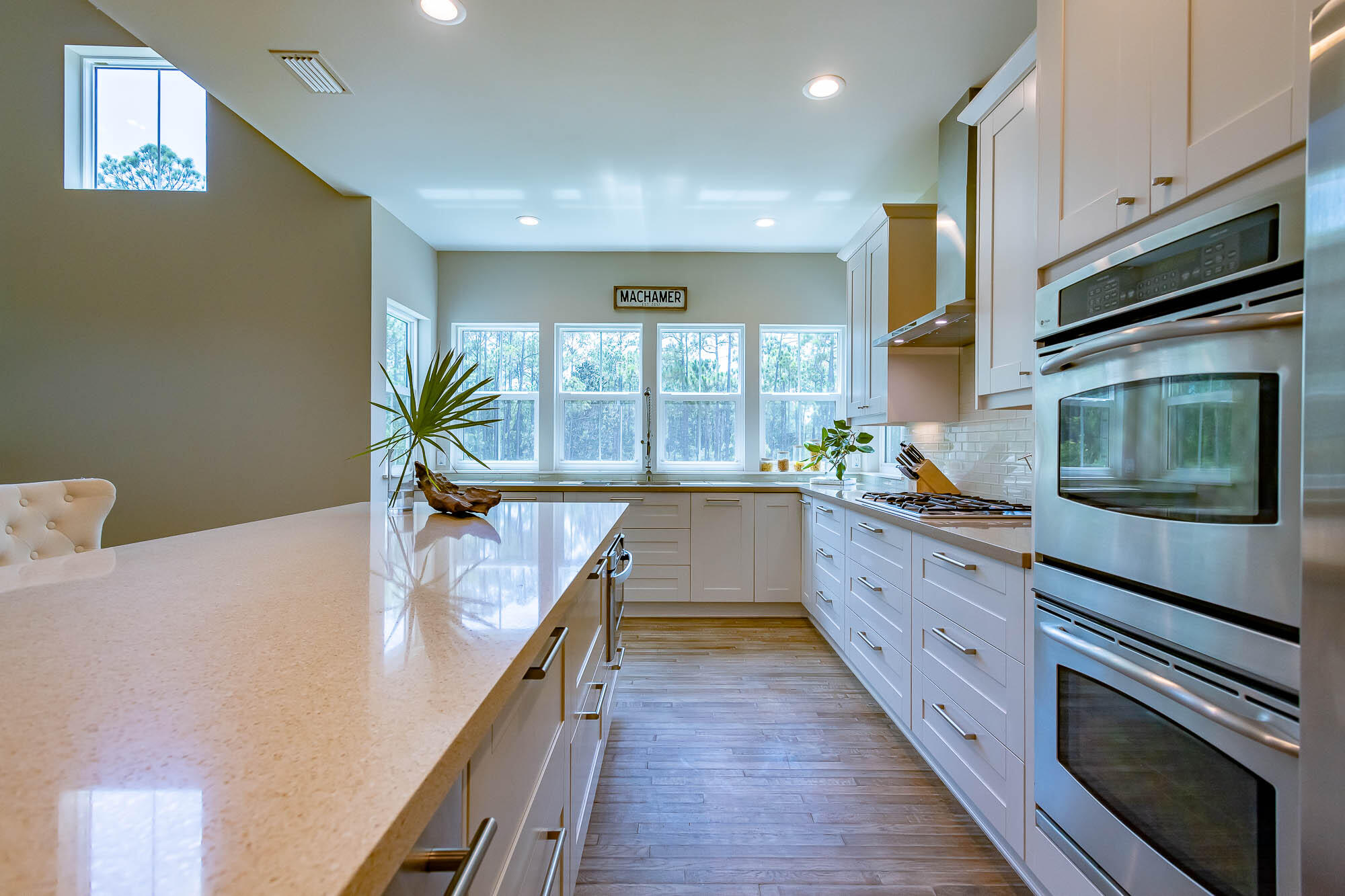 770 North Church Street Santa Rosa Beach, FL 32459 - Photo 27 of 85 a kitchen with stainless steel appliances kitchen island granite countertop a stove a sink and a microwave