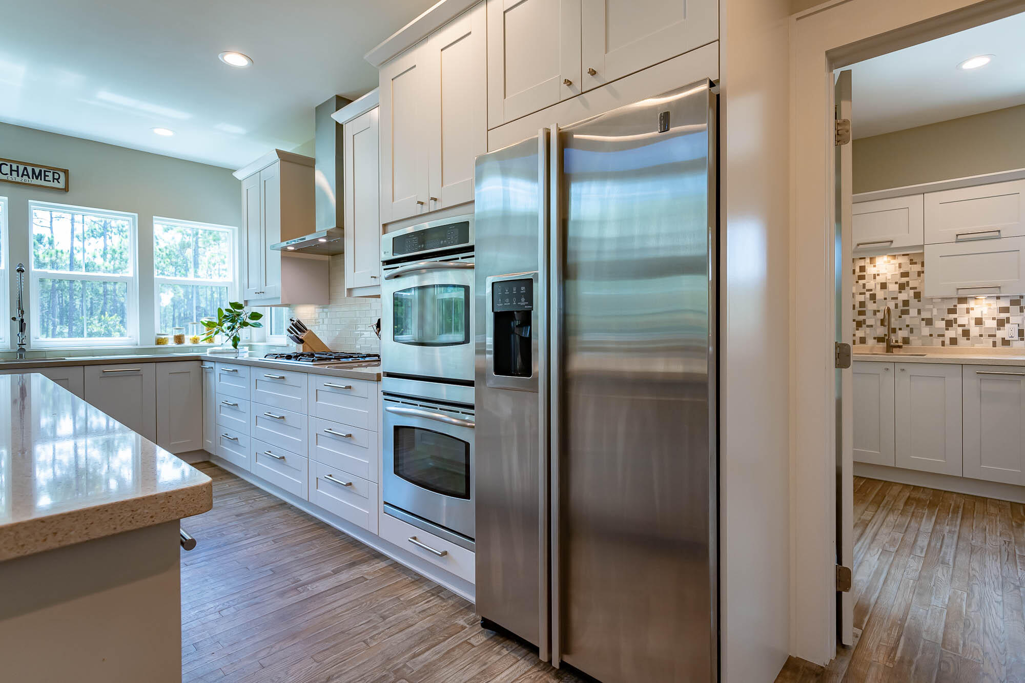 770 North Church Street Santa Rosa Beach, FL 32459 - Photo 28 of 85 a kitchen with stainless steel appliances kitchen island granite countertop a refrigerator and a sink