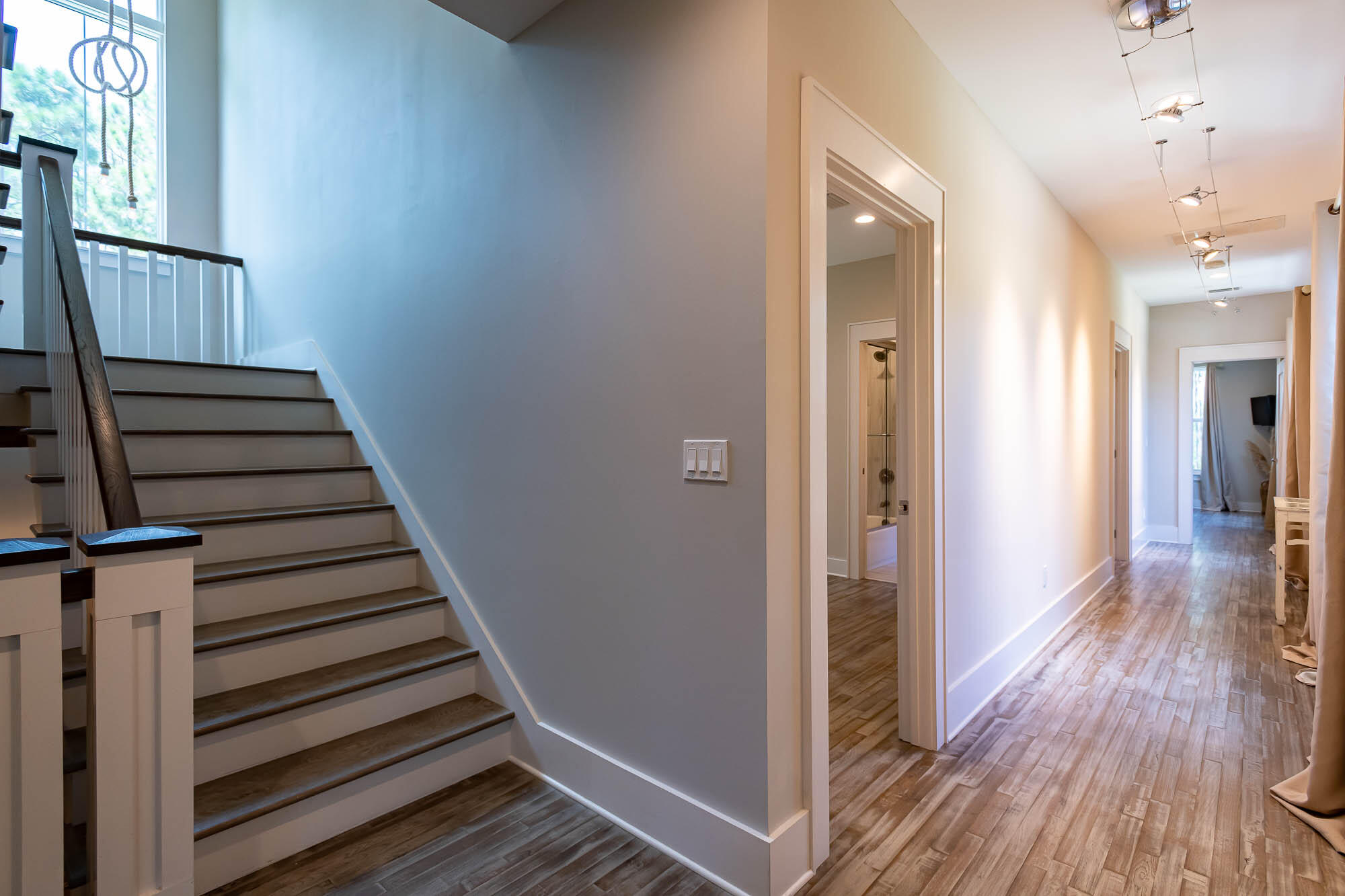 770 North Church Street Santa Rosa Beach, FL 32459 - Photo 39 of 85 a view of a hallway with wooden floor and staircase
