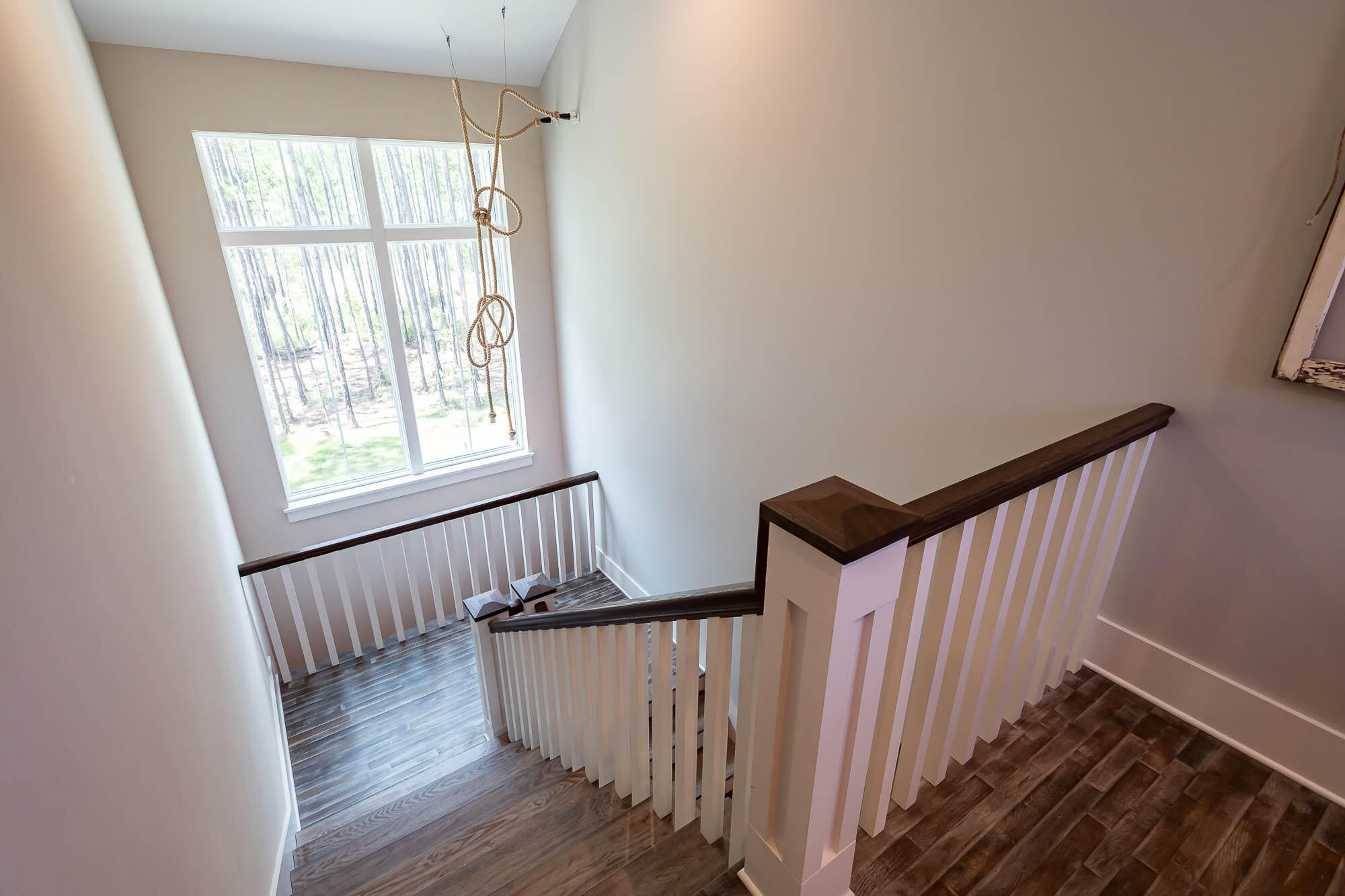 770 North Church Street Santa Rosa Beach, FL 32459 - Photo 48 of 85 a view of a hallway with wooden floor and staircase