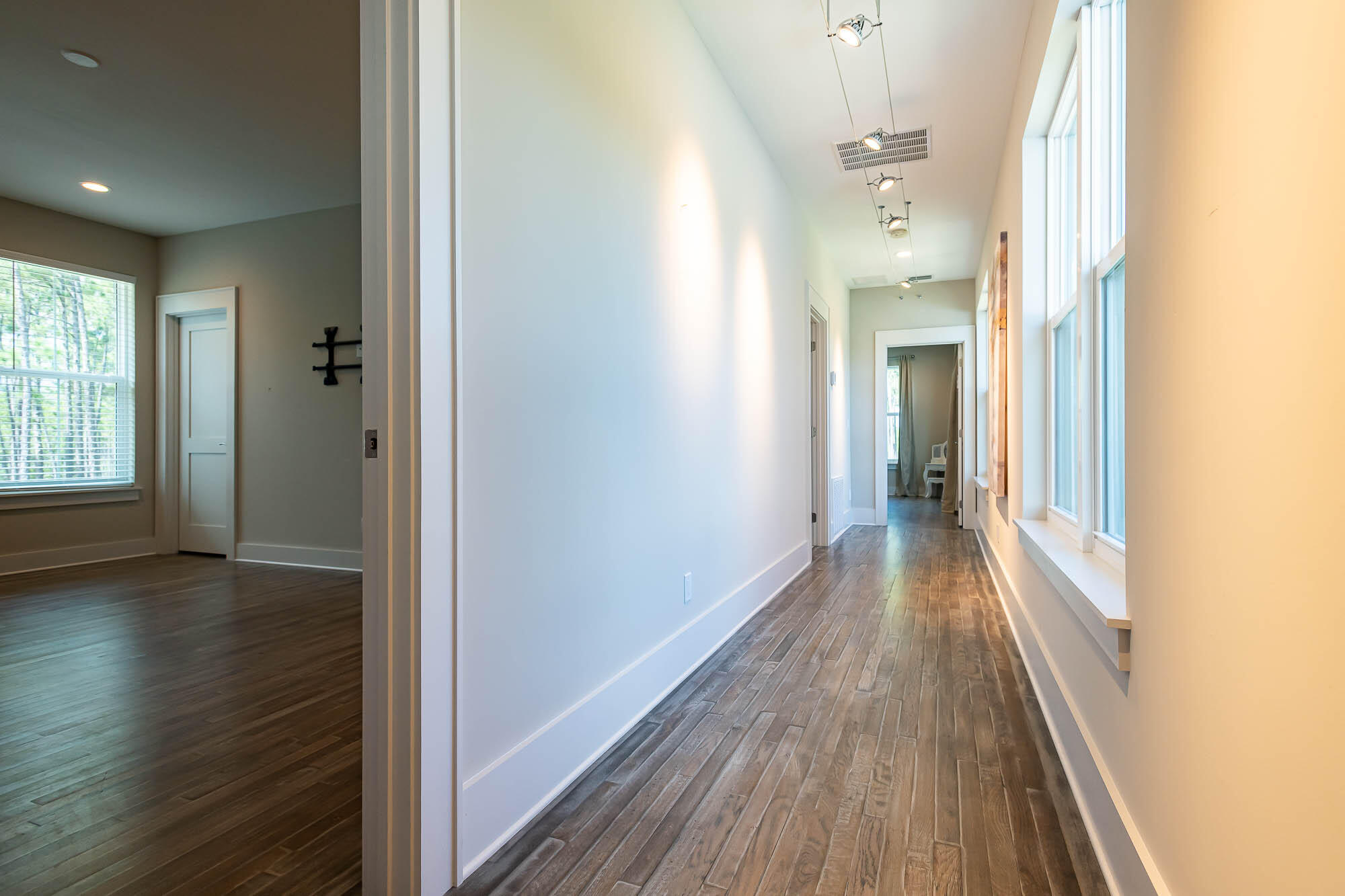 770 North Church Street Santa Rosa Beach, FL 32459 - Photo 56 of 85 a view of a hallway with wooden floor and staircase