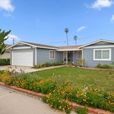 a view of a house with backyard and garden