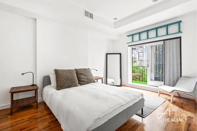a bedroom with a bed and a potted plant