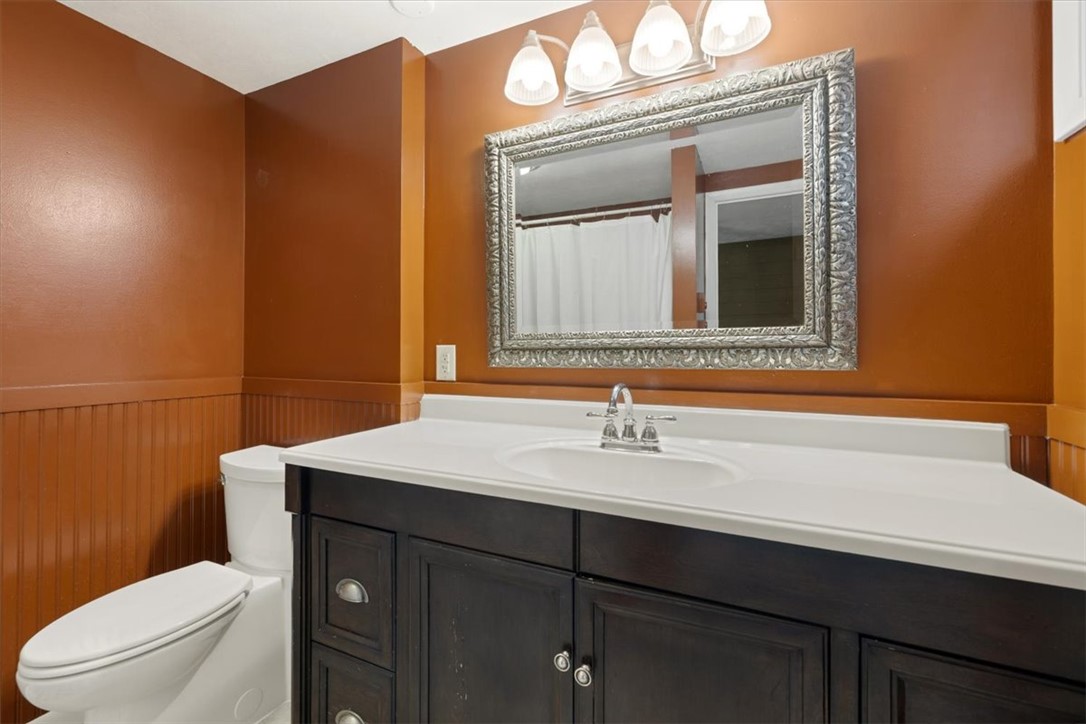 5120 Wheelock Road Troy, OH 45373 - Photo 26 of 67 This bathroom features a single vanity, a toilet, and beadboard paneling, creating a complete and cohesive space.