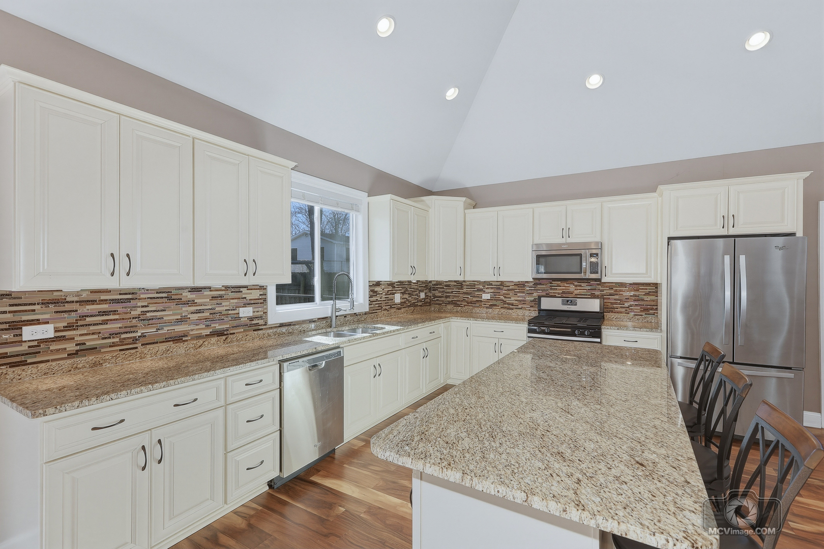 417 Thornton Street Lockport, IL 60441 - Photo 11 of 33 a kitchen with stainless steel appliances granite countertop a sink refrigerator and cabinets