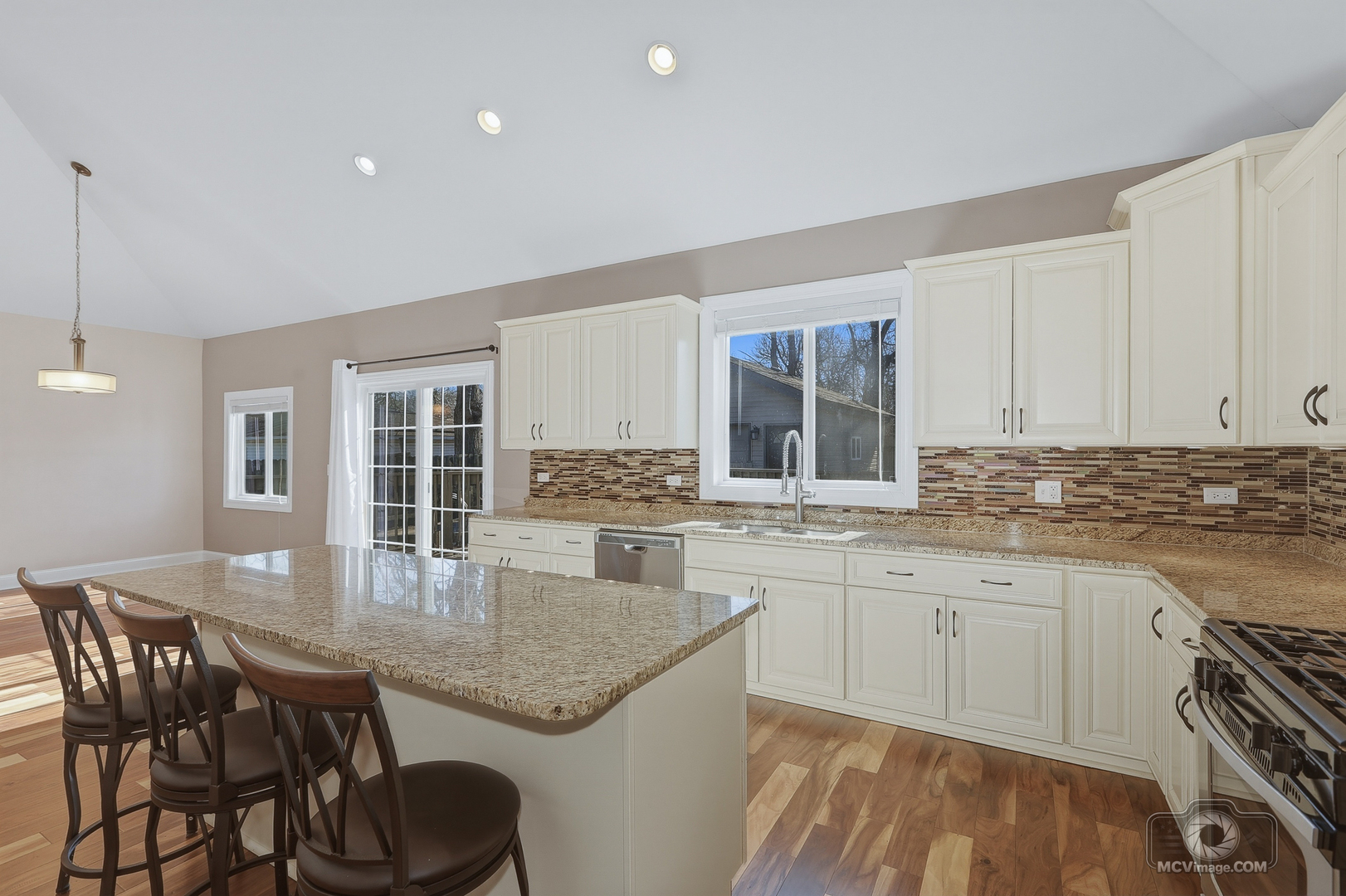 417 Thornton Street Lockport, IL 60441 - Photo 13 of 33 a kitchen with a kitchen island hardwood floor sink stove and dining table