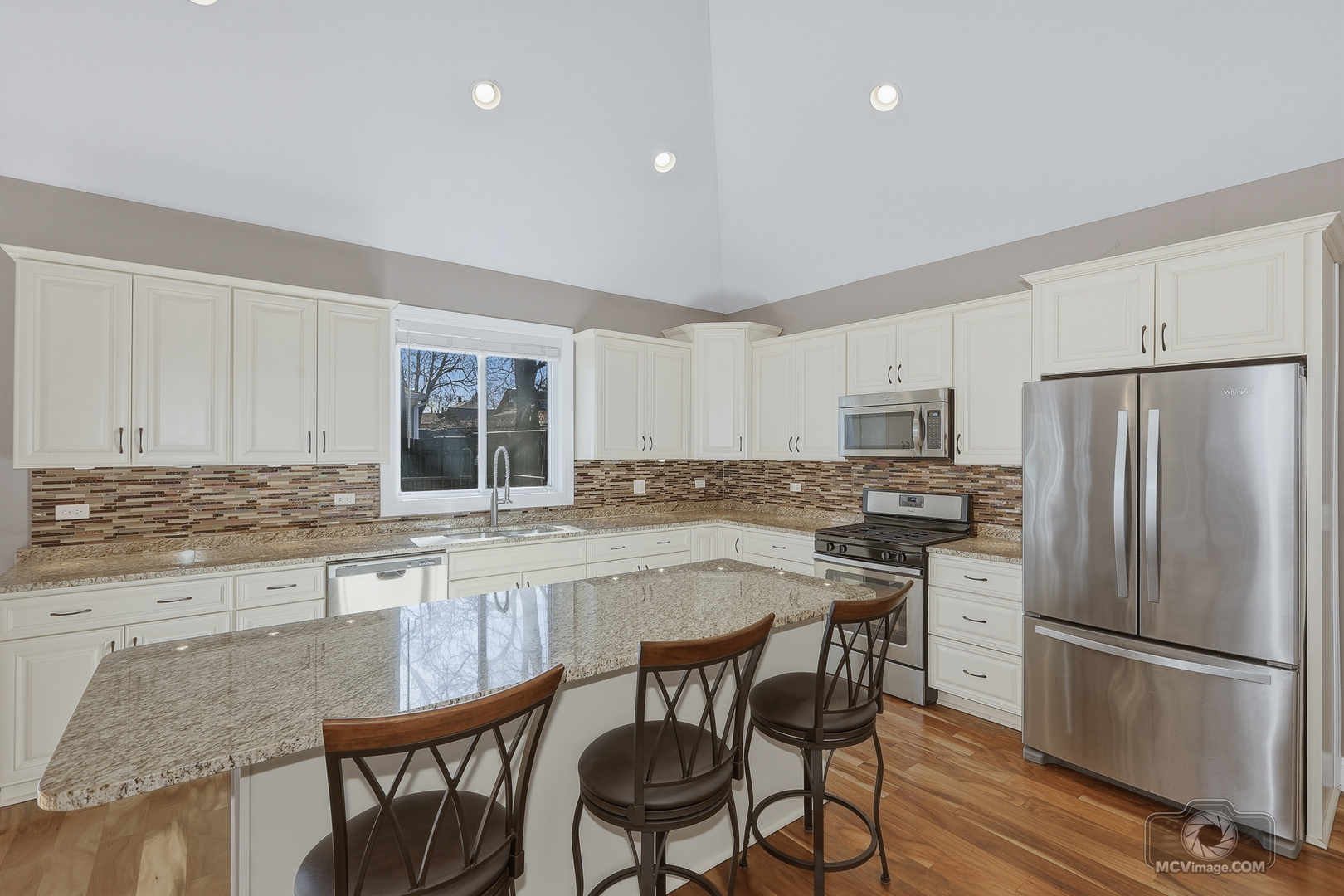 417 Thornton Street Lockport, IL 60441 - Photo 14 of 33 a kitchen with stainless steel appliances a dining table chairs refrigerator and cabinets