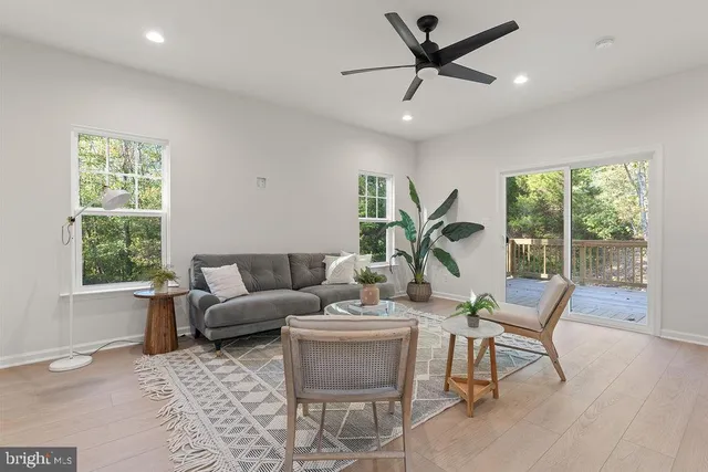 a bathroom with a toilet a sink a mirror and a window