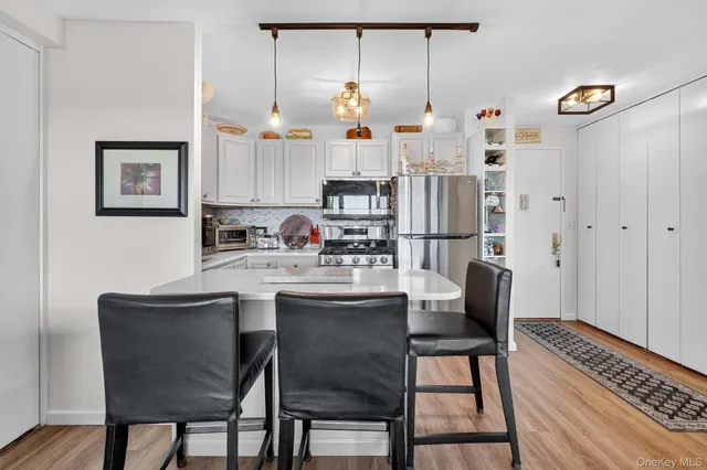 a kitchen with stainless steel appliances granite countertop a sink refrigerator and microwave