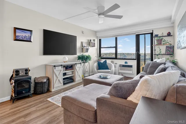 a kitchen with stainless steel appliances granite countertop a dining table chairs and a refrigerator
